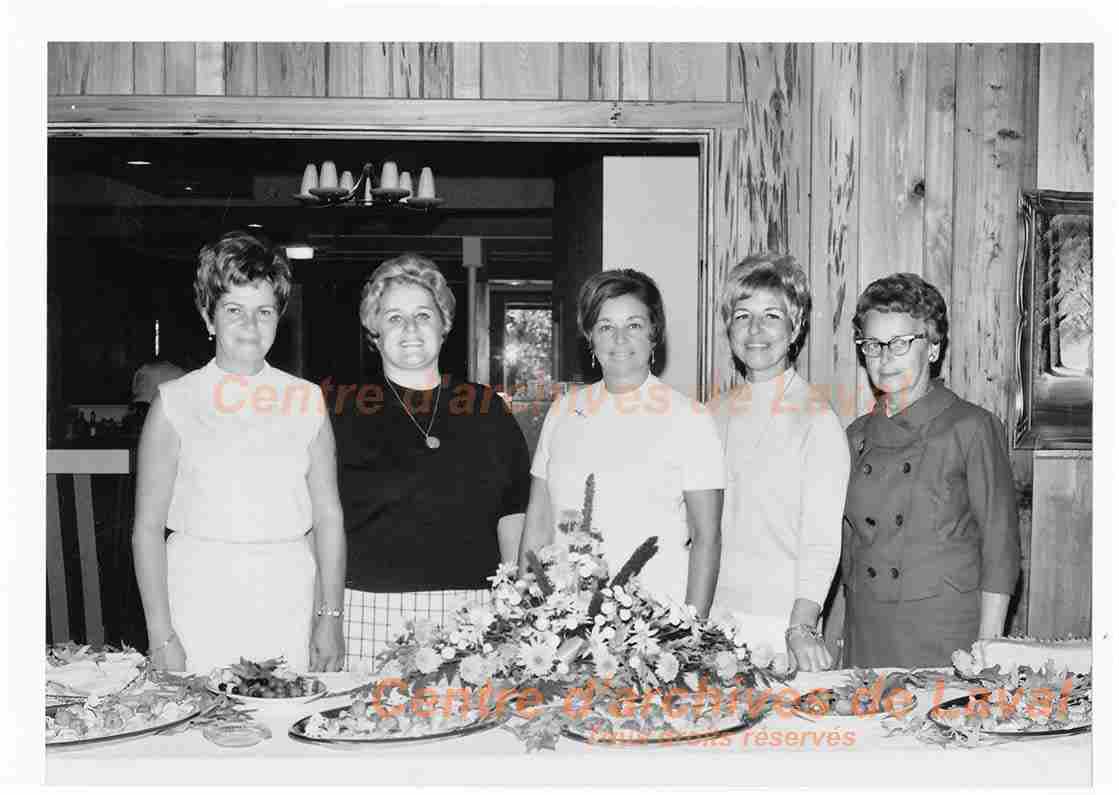 Cinq personnes non identifies poses avec des plateaux de nourriture