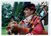 Deux personnes non identifiées en habits écossais jouant de la cornemuse